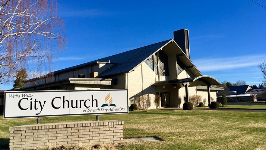 A sign in front of a church building reads "Walla Walla City Church of Seventh-Day Adventists”