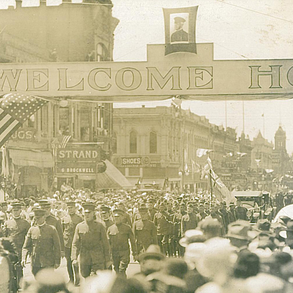 Sepia-toned image depicting WWI veterans parading through downtown Walla Walla.