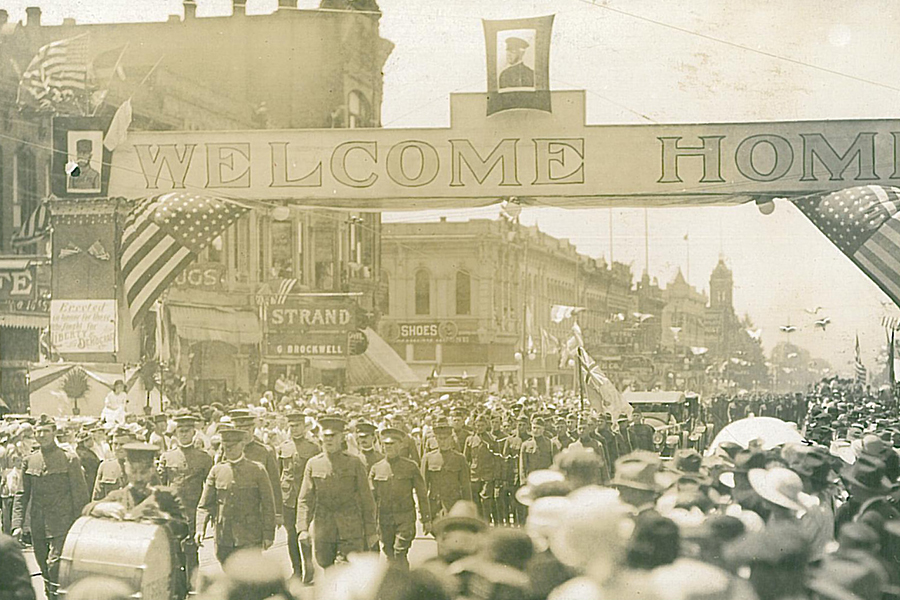 Sepia-toned image depicting WWI veterans parading through downtown Walla Walla.