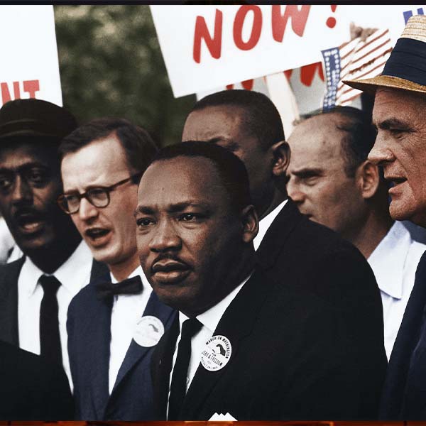 A colorized photo of Martin Luther King, Jr. in a crowd of demonstrators.