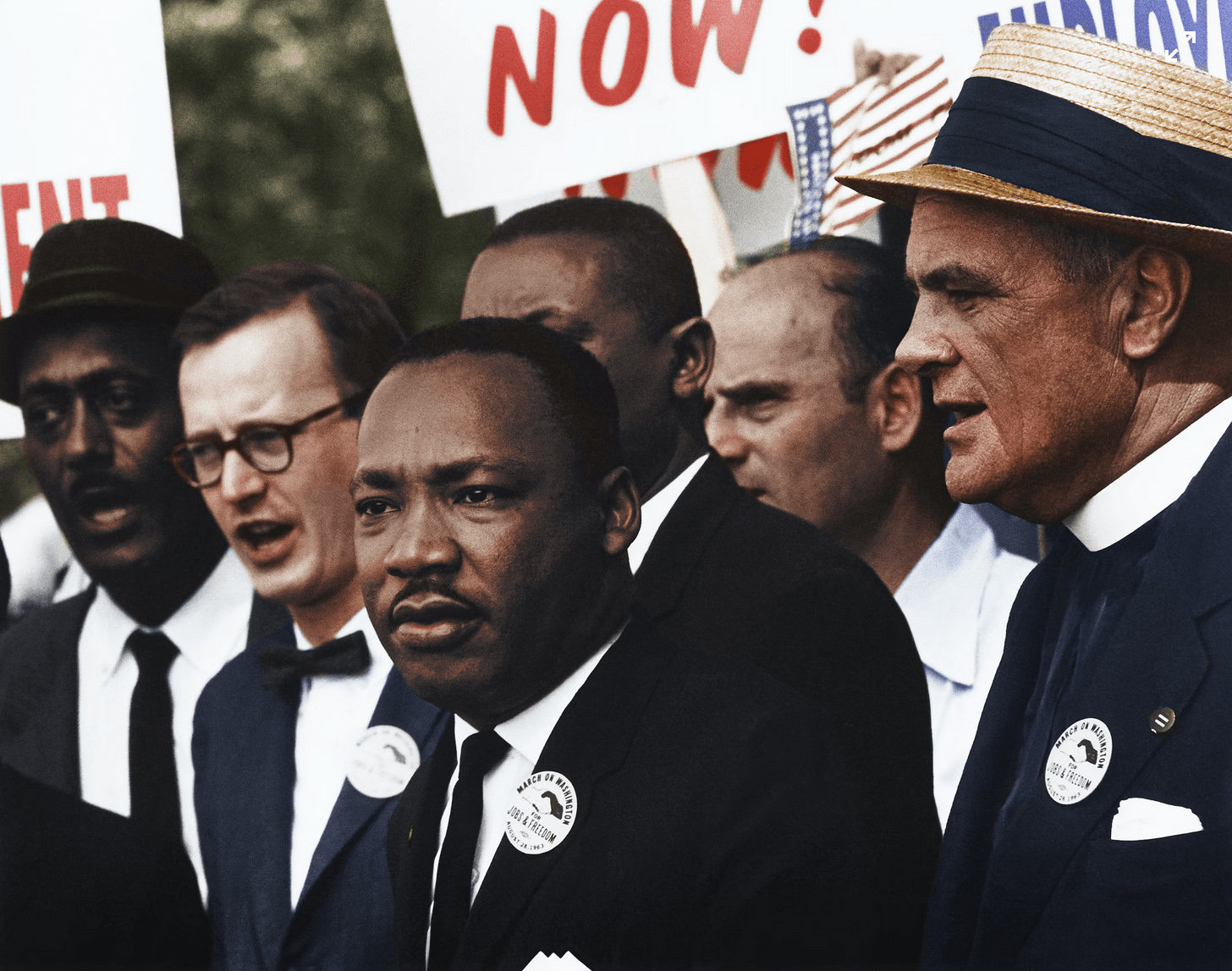 A colorized photo of Martin Luther King, Jr. in a crowd of demonstrators.