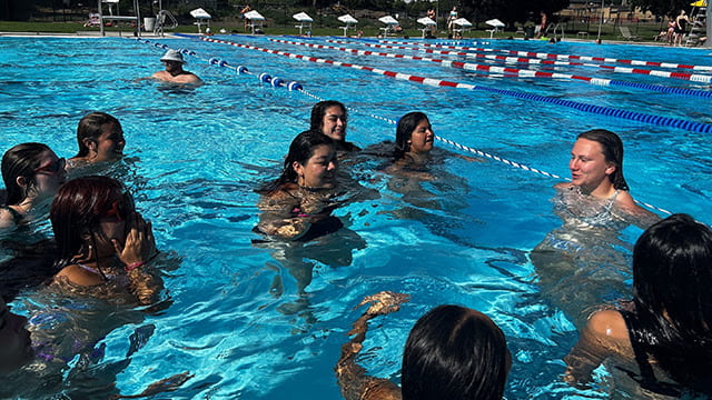 People cooling off in a swimming pool.