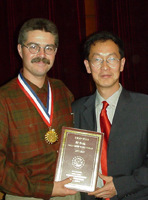 Chas McKhann, '79, left, was honored for his service to the people of China. His former student Gan Xuechun, (Whitman 1994-95), right, is director of Yunnan University's international exchange programs.