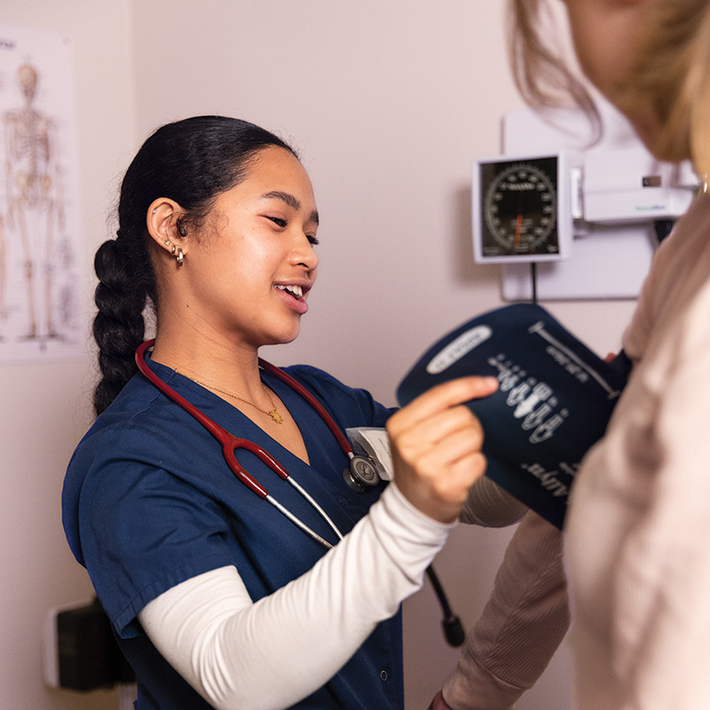 A pre-health Whitman College student checking blood pressure.