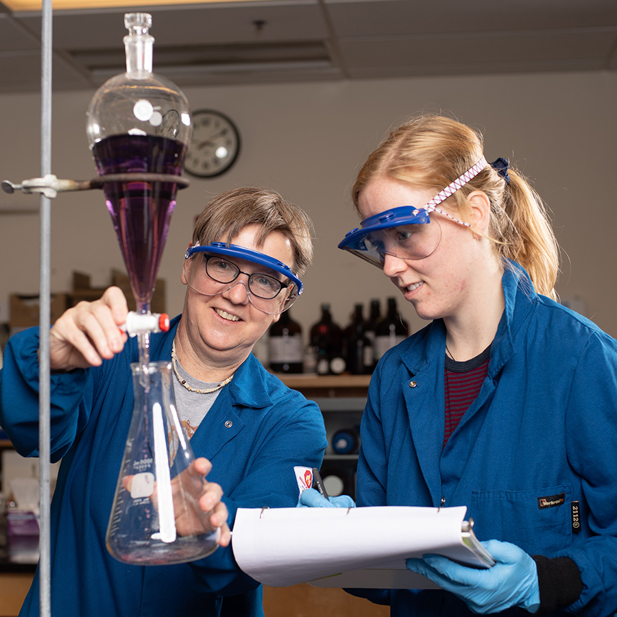 Marion Götz working in a lab with a Whitman College student.