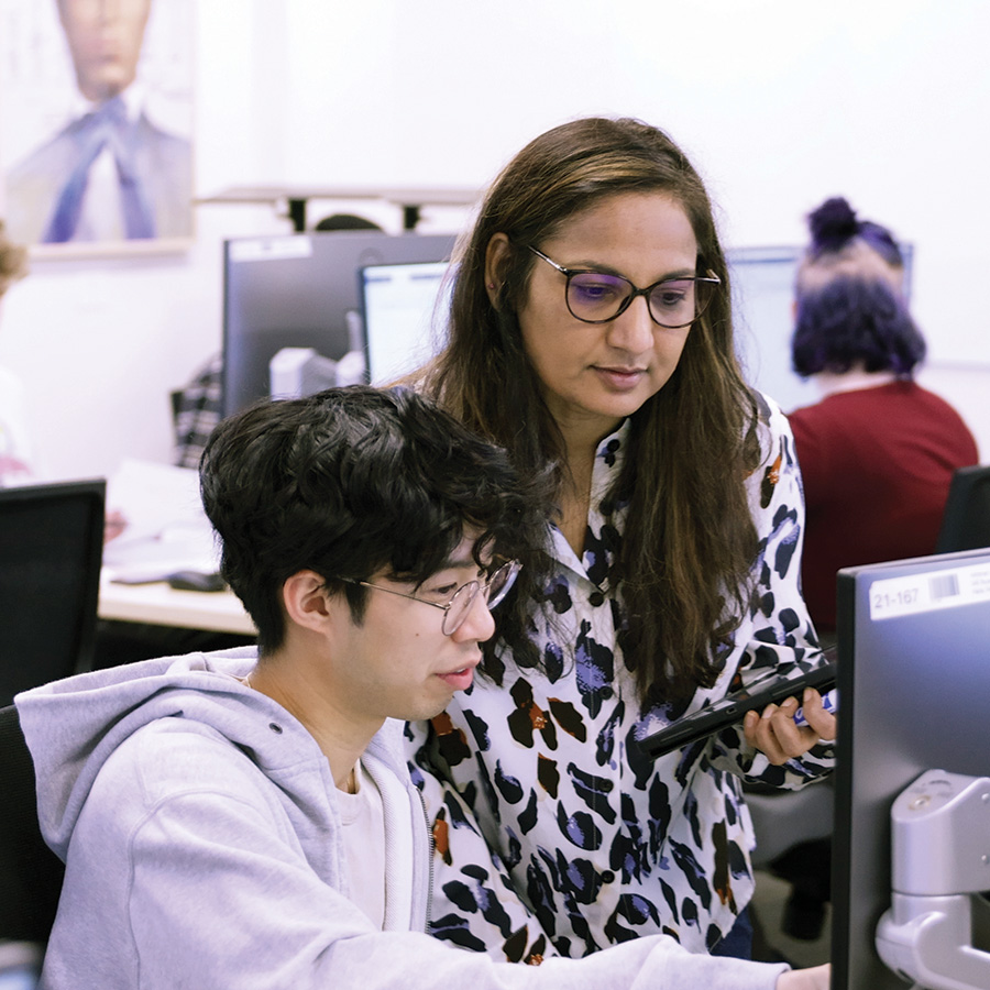 Professor Dalia Biswa working with a Whitman College student on a computer.