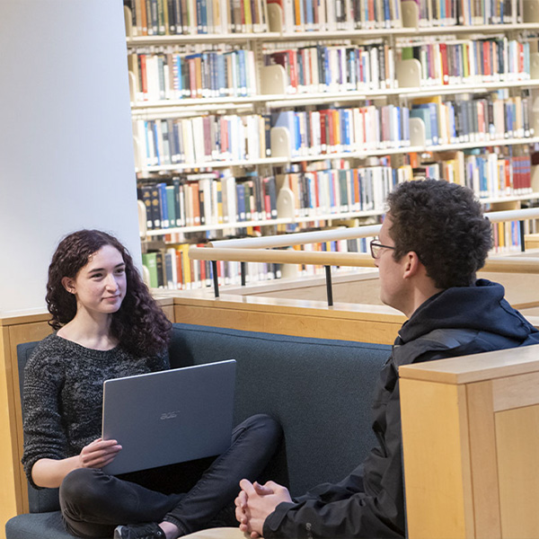 Students talking in library.