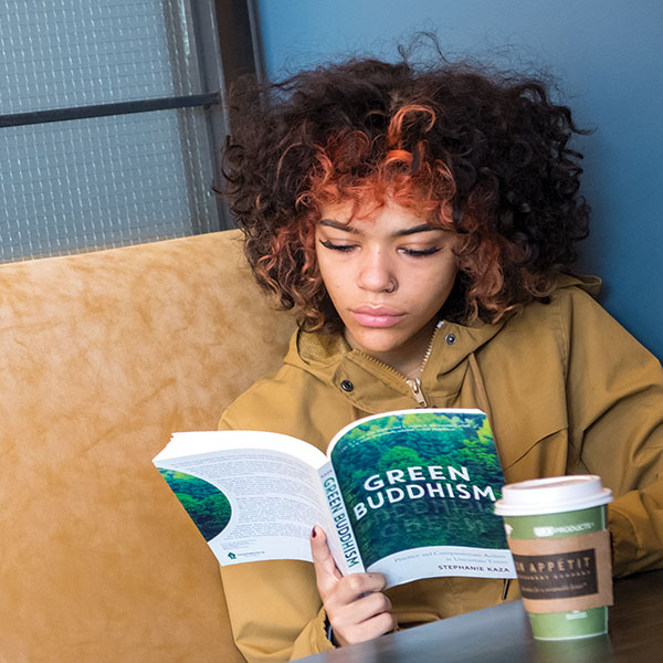 Whitman College student reading a philosophy book.