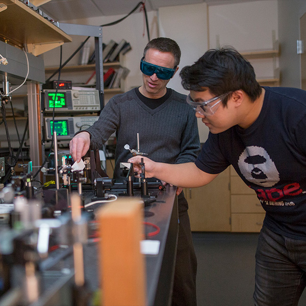 A Whitman College student conduction a physics experiment with a Whitman College professor.