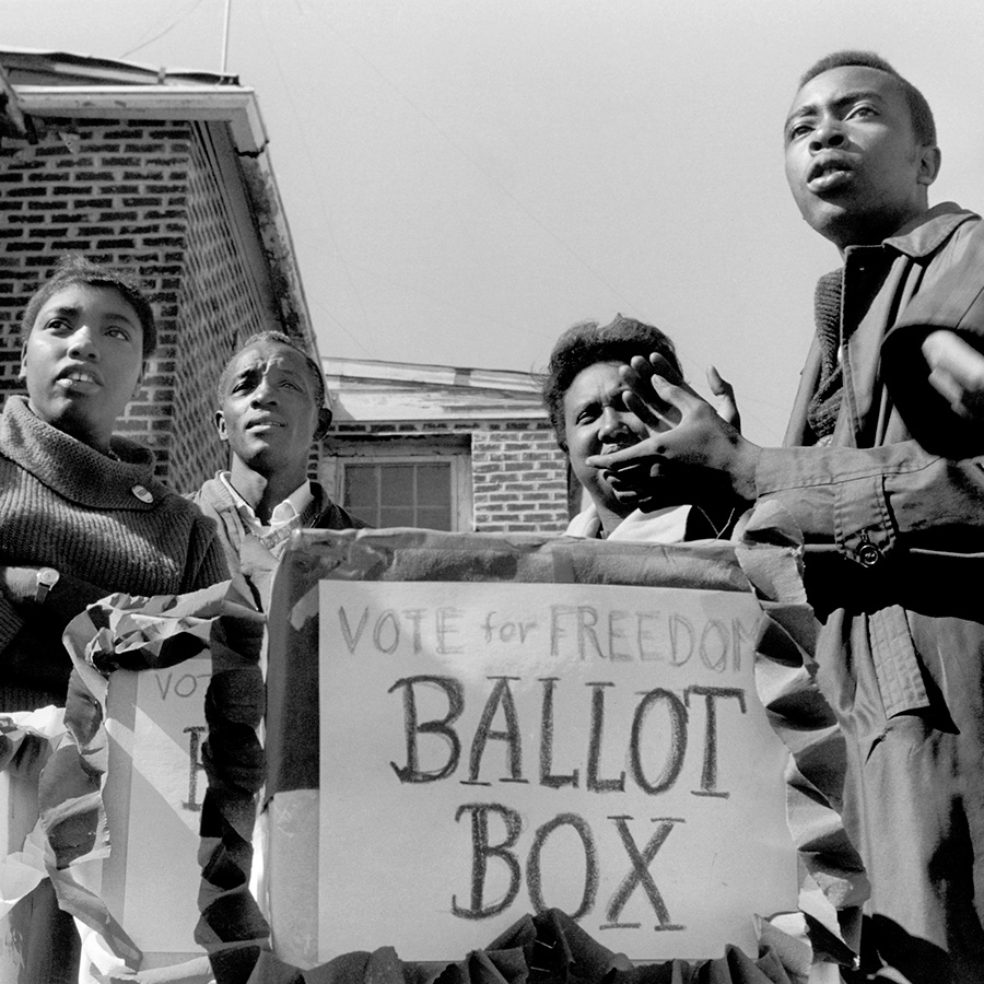 Citizens surrounding a ballot box encouraging to "Vote for freedom".