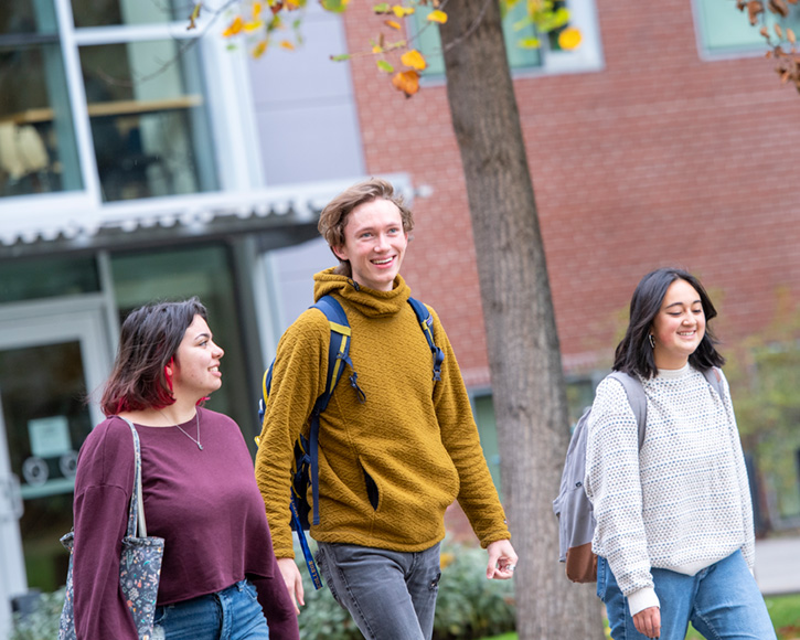 students walking on campus in front of the Hall of Science building at Whitman College