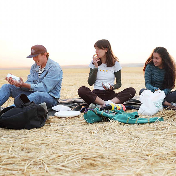 Student in the wheat fields eating burritos