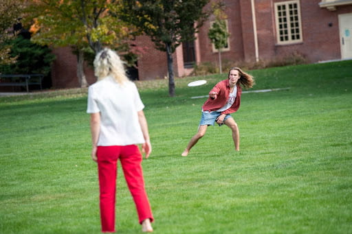 Students playing frisbee on Ankeny field.