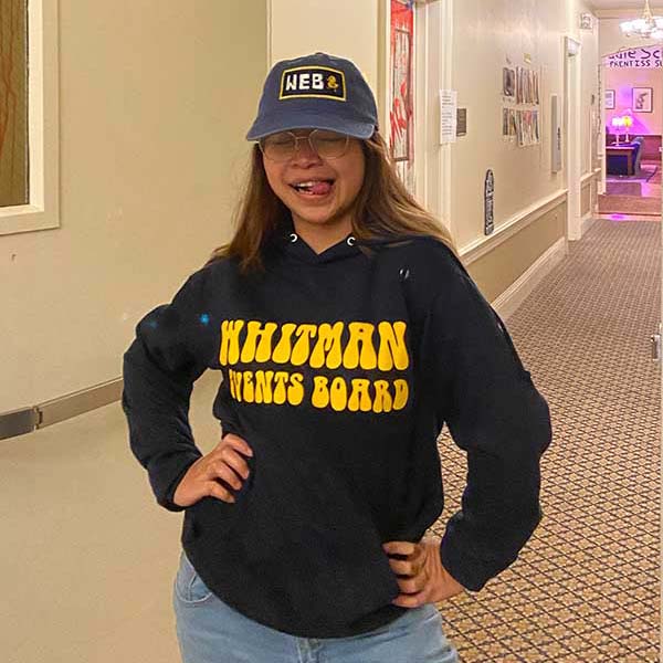 Gelic Gerona wearing a Whitman College sweatshirt.