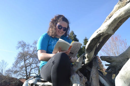 Zoe Perkins reading outdoors on Styx.