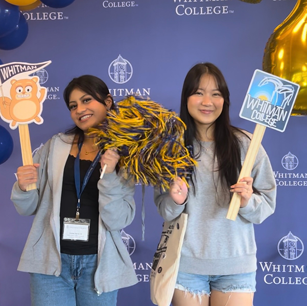 Two admitted students at Whitman College celebrating in a photo booth