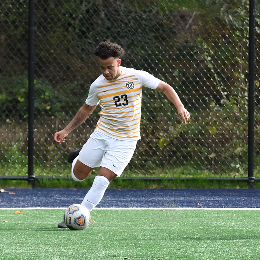 Whitman College Soccer player preparing to kick the soccer ball. 