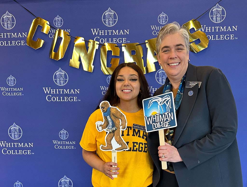 Jacqueline Luna and President Sara Bolton holding Whitman College signs.