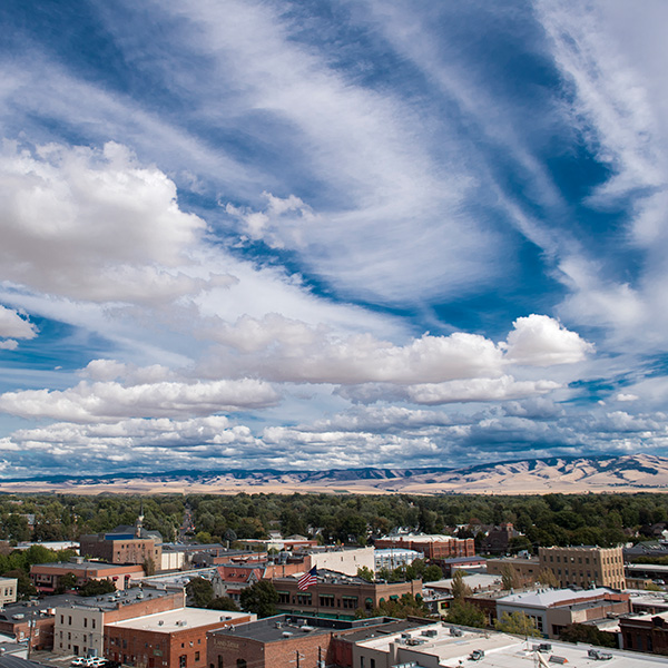 Picture of the Walla Walla valley with blue skies and white clouds.