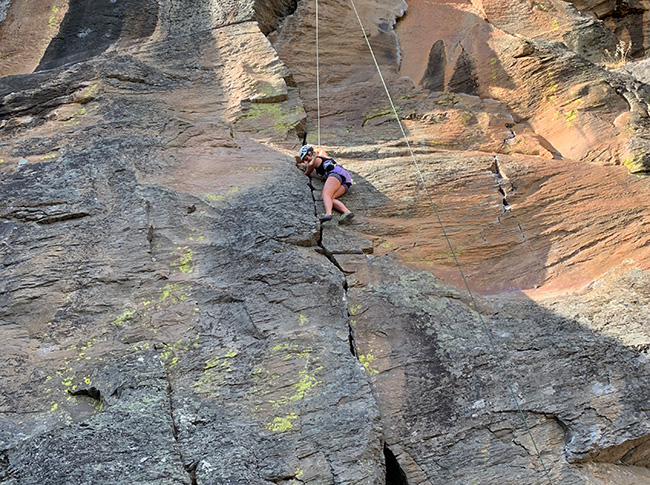 Whitman College student rock climbing.