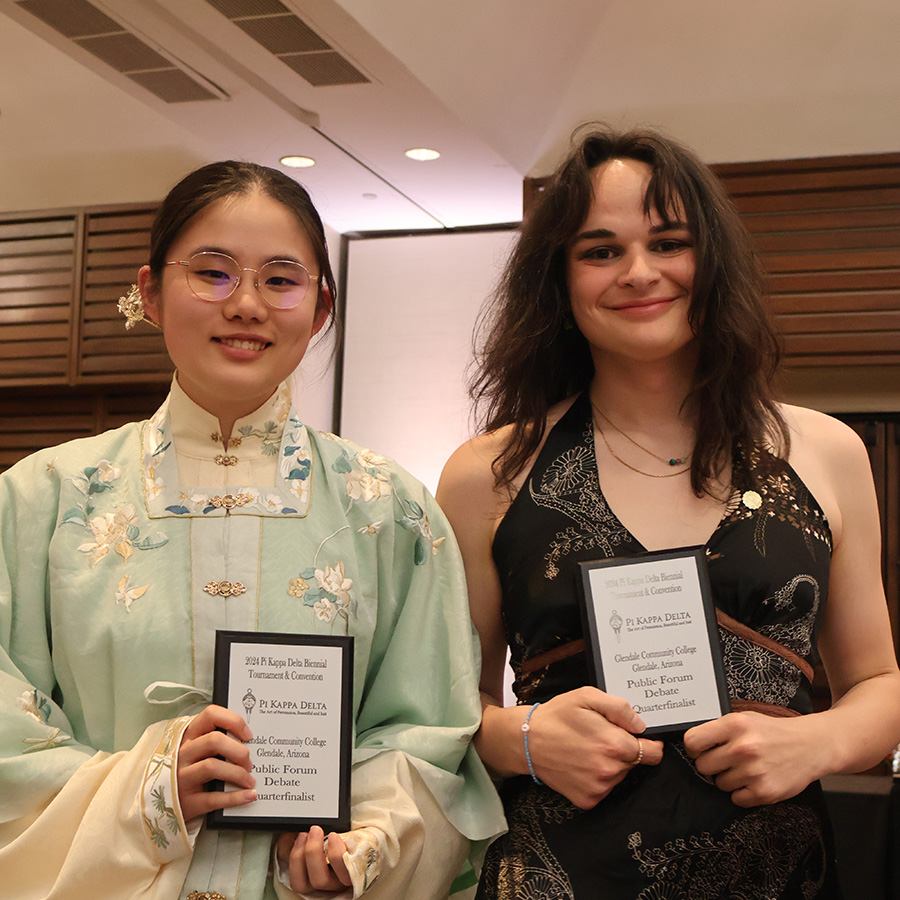 Whitman College students holding their competition awards.