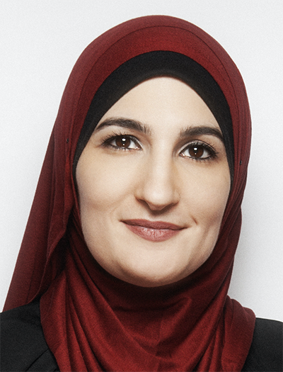 portrait of Linda Sarsour wearing a red and black headscarf