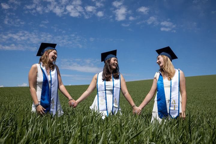 Graduates standing in a field
