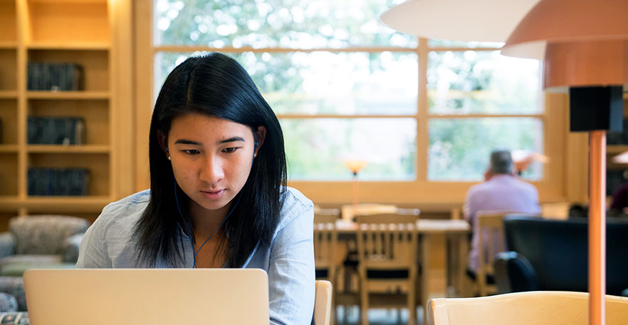 Student at a computer in Penrose Library