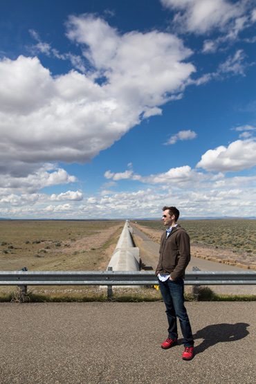 Greg Ogin standing outside one of the arms of the Hanford LIGO site