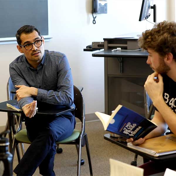 Whitman professor speaking with a student