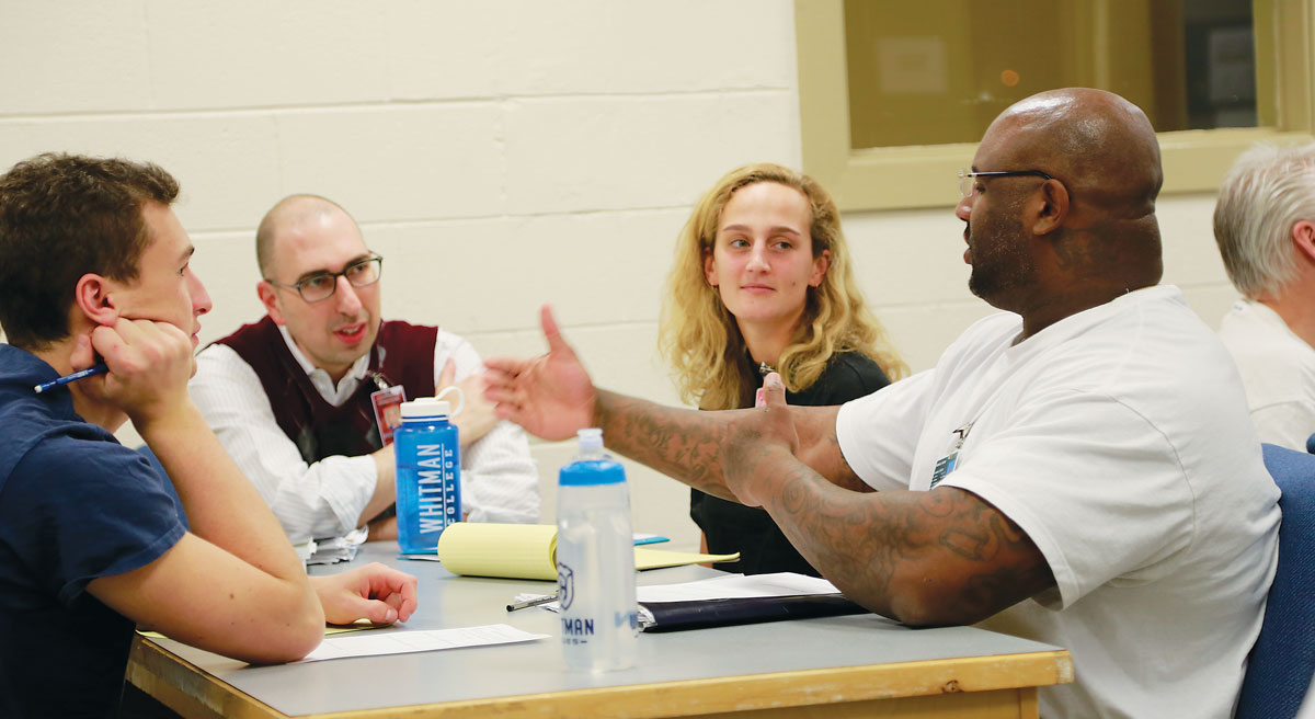Mitch Clearfield and students speak with a prison inmate