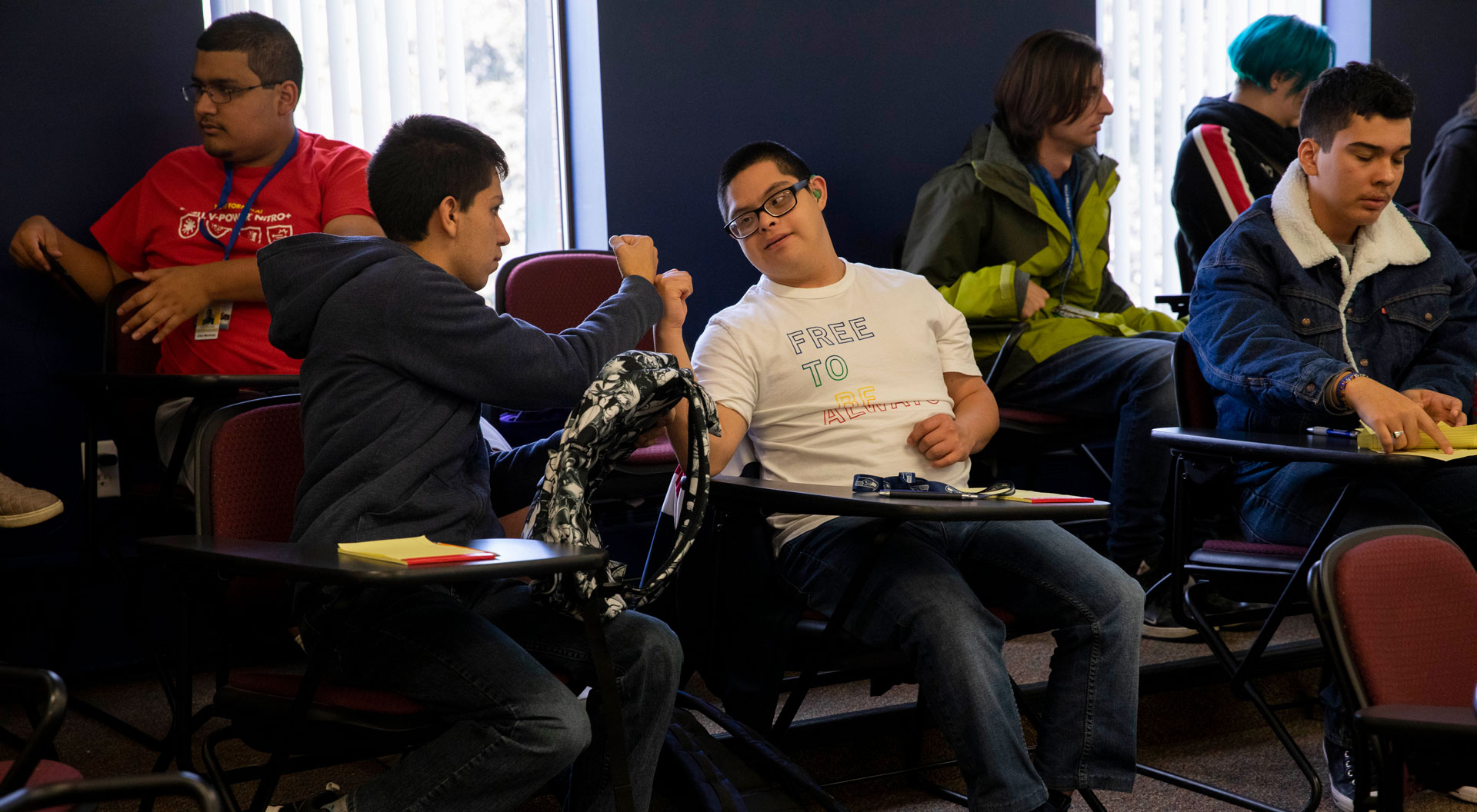 Students enrolled in the sociology course SOC 294: Fefining Ability and Developing Community give each other a fist-bump during class in October. 