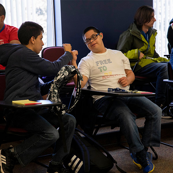 Students enrolled in the sociology course SOC 294: Fefining Ability and Developing Community give each other a fist-bump during class in October. 