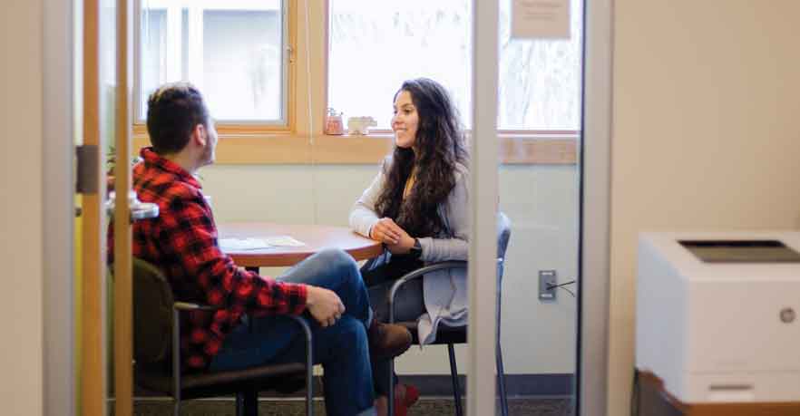 Mitzy Rodriguez Camiro, a career coach, speaks with a student