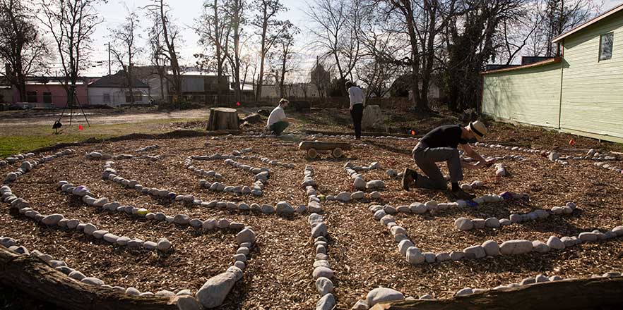 A student tends to Whitman’s labyrinth