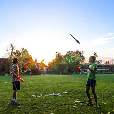 Two students juggling on Ankeny field