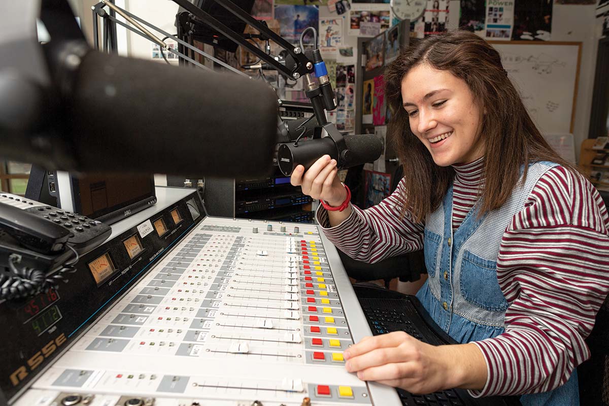 Claire Andrus working at KWCW in the studio