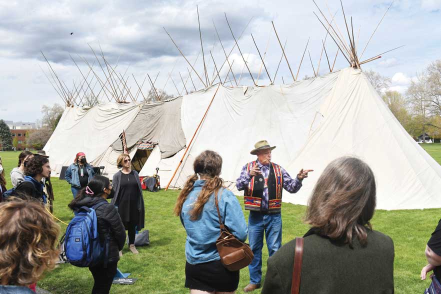 Whitman alum Roger Amerman teaches “Long Tent 101” in front of the Plateau Long Tent—believed to be the first ever built on a college campus—that stood on Ankeny Field from April 18-26, 2022. 