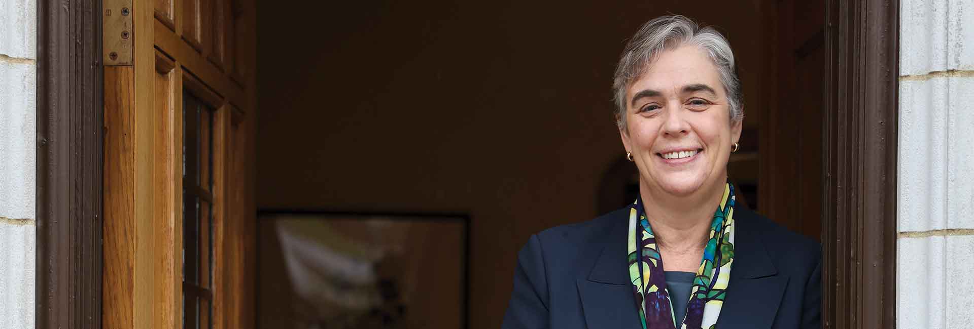 Whitman College's 15th President, Sarah Bolton standing in a doorway