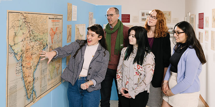 Krista Gulbransen and students looking at a map.