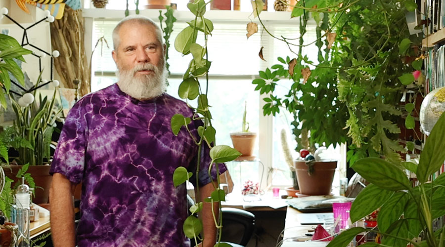 Frank Dunnivant in their office surrounded by plants.