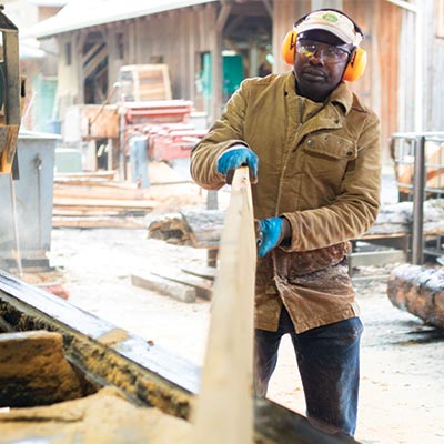 Cutting planks in a wood mill.