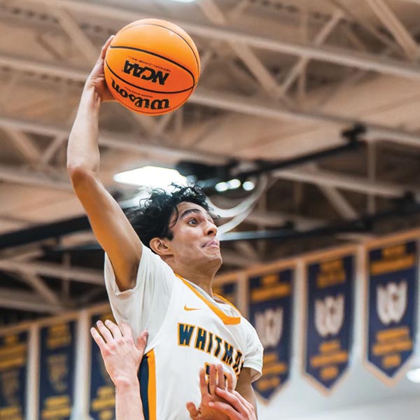 Jai Desphande about to dunk a basketball.