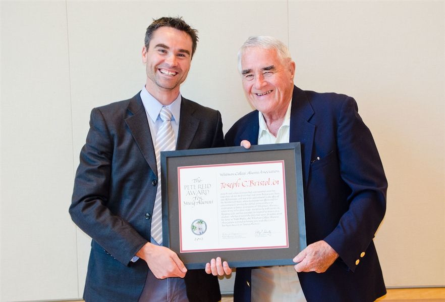 Pete Reid presents Joseph Bristol '01 (left) with the Pete Reid Award in 2012. He works as a Foreign Service Officer for the State Department in Washington, D.C.