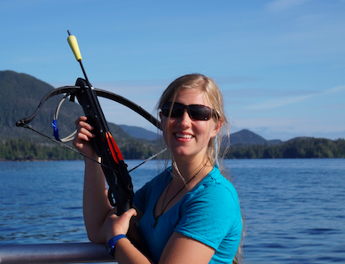Baker in the Sitka Sound with a biopsy crossbow, a scientific instrument used to analyze genetic samples of whale skin and blubber with minimal invasion. Photo courtesy of Nevé Baker.