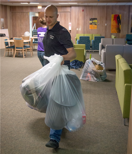 Kiesz carries a handful of the hundreds of plastic bags of practical goods that Whitman students donated during move-out week in May.