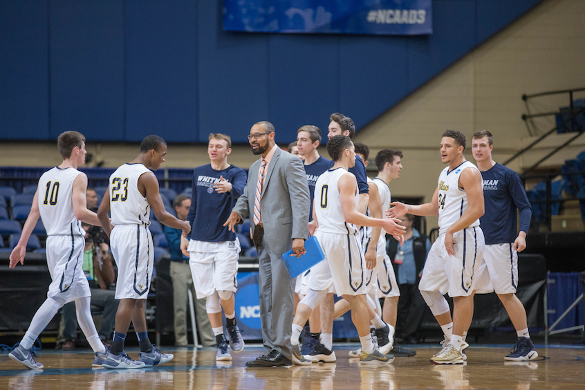 Assistant Men’s Basketball Coach Stephen Garnett (center) congratulated good play early into the action.
