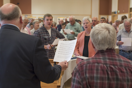Blake Ladenburg '17 (center left), senior fund chair and an economics major, and President Murray (center right) join the class of 1967 and Whitman staff in a rendition of the "Whitman Hymn" to conclude the luncheon.