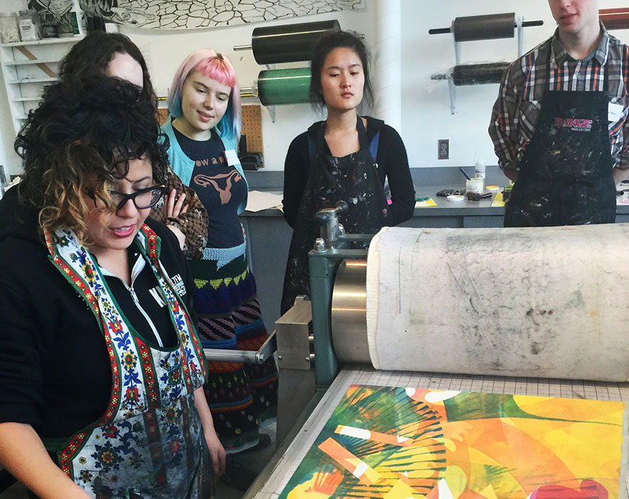 Students in Associate Professor of Art Nicole Pietrantoni's beginning and intermediate printmaking classes observe as Rodriguez demonstrates various monoprinting techniques during her 2016 visit to Whitman.  