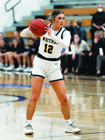Whitman college basketball player on the court.